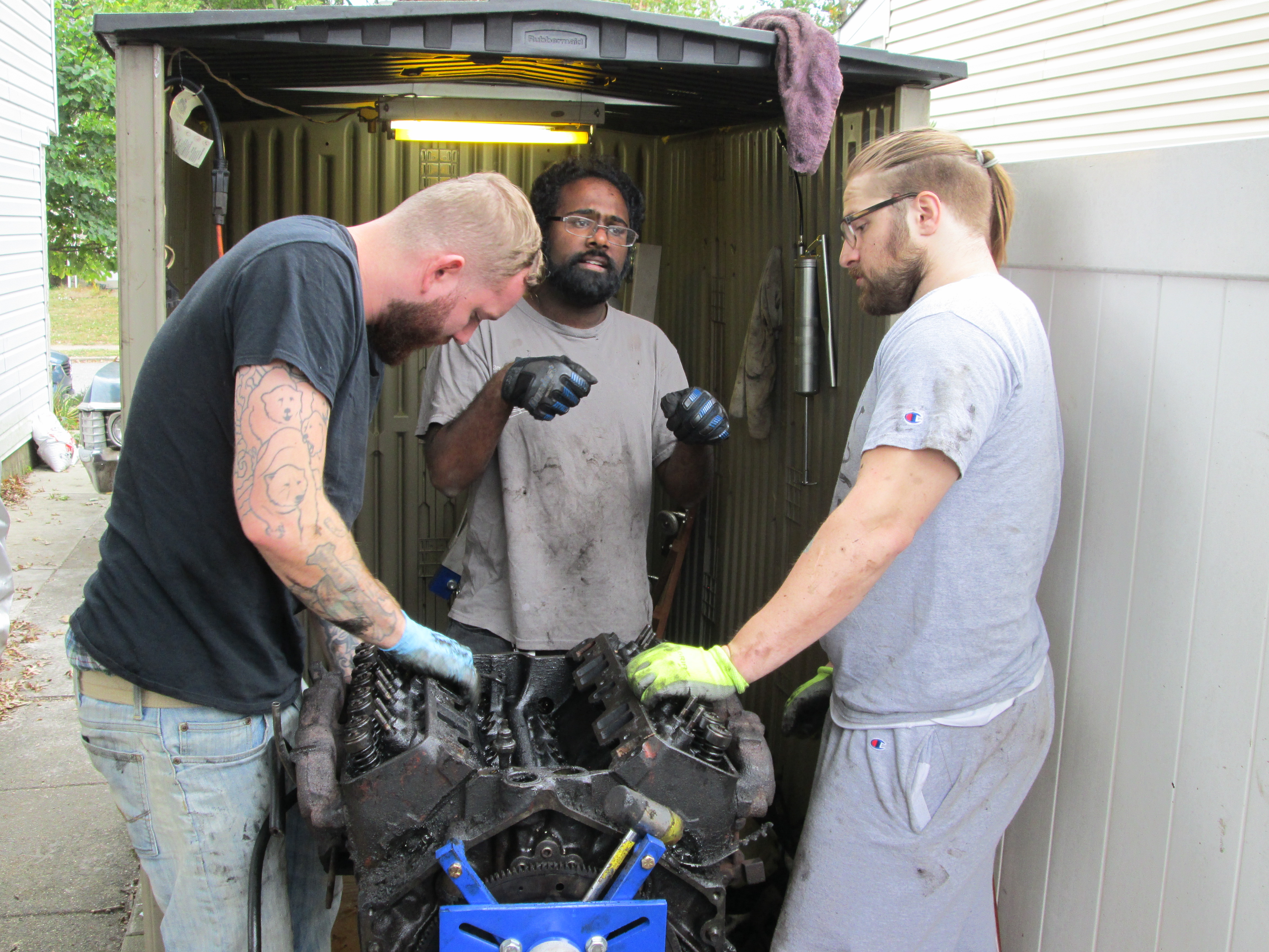 Brandon, Stephen, and Nick work on the engine